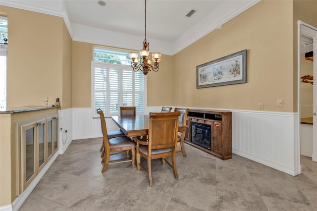 dining space featuring an inviting chandelier and crown molding