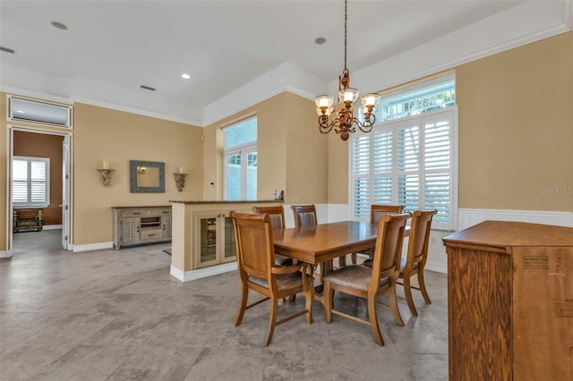 dining area featuring a chandelier and crown molding