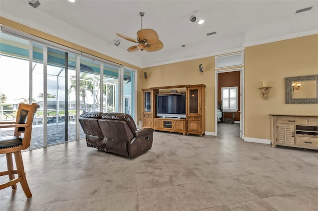 living room with ceiling fan, ornamental molding, and a healthy amount of sunlight