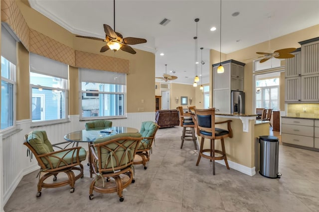 dining area with ornamental molding and ceiling fan