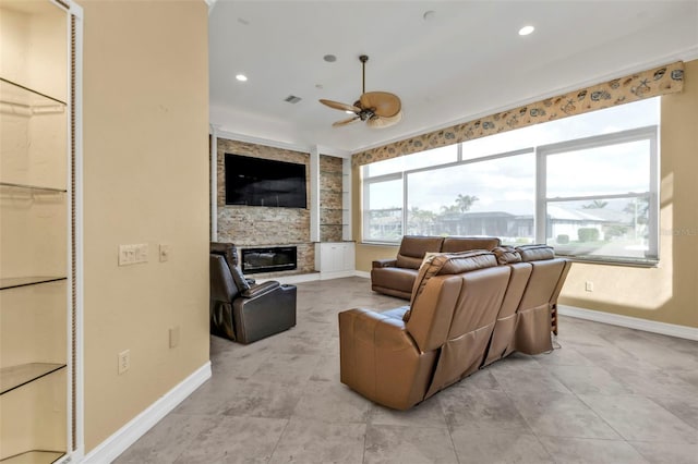 tiled living room featuring ceiling fan and a stone fireplace