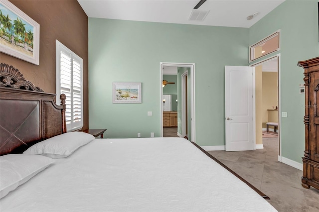 bedroom featuring ceiling fan, light tile patterned floors, and ensuite bath