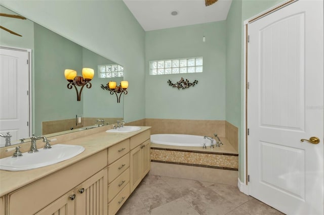 bathroom featuring vanity and tiled tub