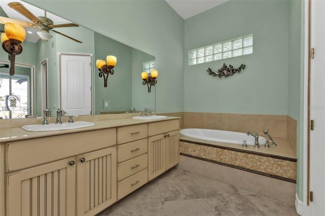 bathroom featuring ceiling fan, tile patterned flooring, vanity, and a relaxing tiled tub