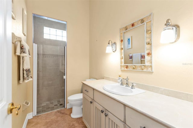 bathroom featuring tile patterned floors, vanity, toilet, and walk in shower