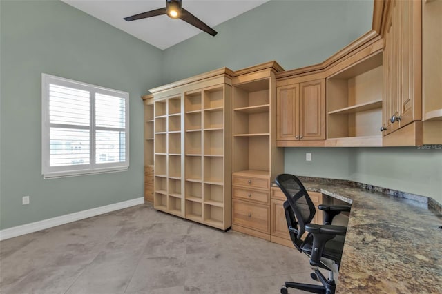 office area with ceiling fan and built in desk