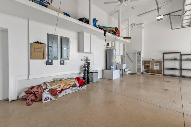 garage with electric water heater, ceiling fan, and a garage door opener