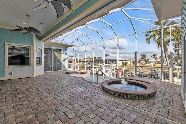 view of patio / terrace with an in ground hot tub, ceiling fan, and a lanai