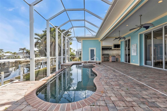 view of swimming pool with a patio, area for grilling, a grill, glass enclosure, and ceiling fan