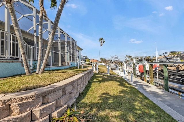 view of community featuring a dock and a lawn