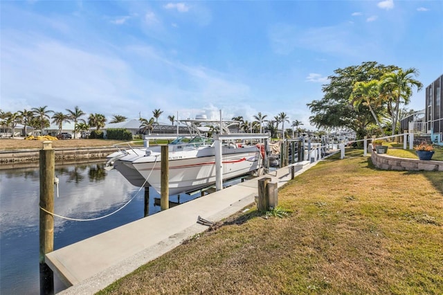 dock area with a yard and a water view