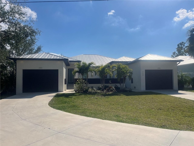 view of front of home with a garage and a front lawn