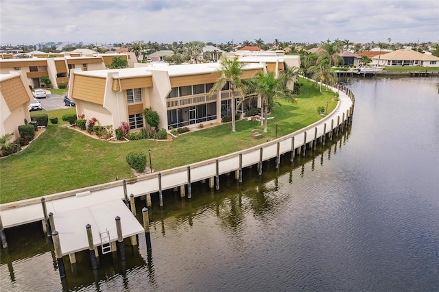 drone / aerial view with a water view and a residential view