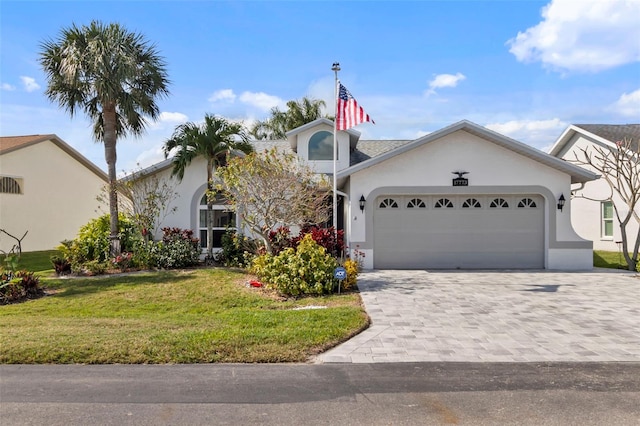 view of front of property with a garage and a front lawn