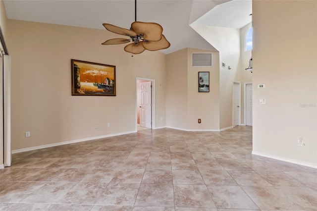 tiled spare room featuring ceiling fan and high vaulted ceiling