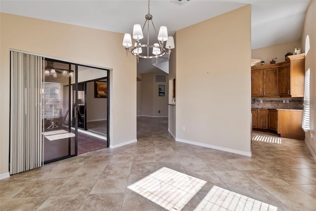 unfurnished dining area featuring an inviting chandelier and light tile patterned floors