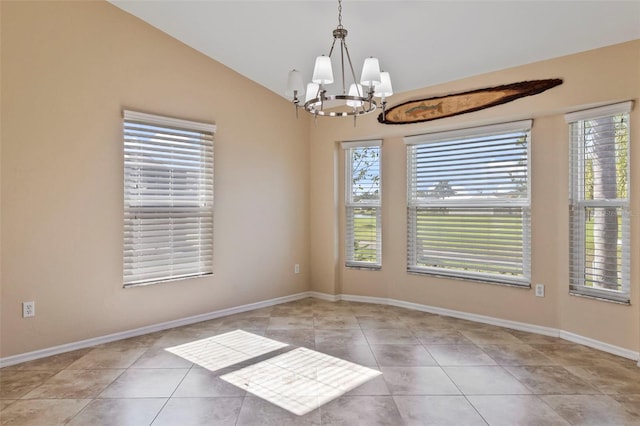 empty room featuring light tile patterned flooring, lofted ceiling, a healthy amount of sunlight, and a chandelier