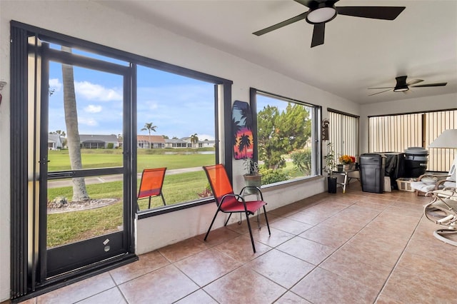 sunroom featuring ceiling fan