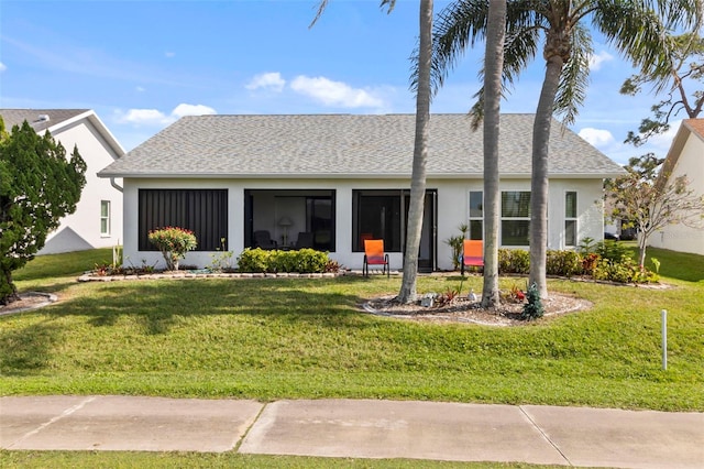 single story home featuring a front lawn