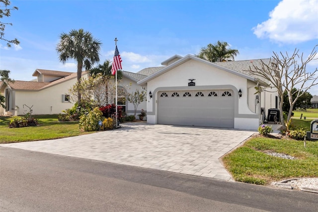 view of front facade featuring a garage and a front lawn