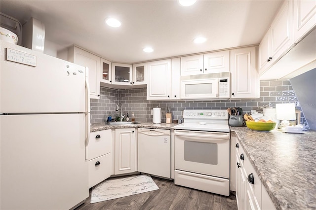 kitchen with white cabinetry, sink, backsplash, dark hardwood / wood-style flooring, and white appliances