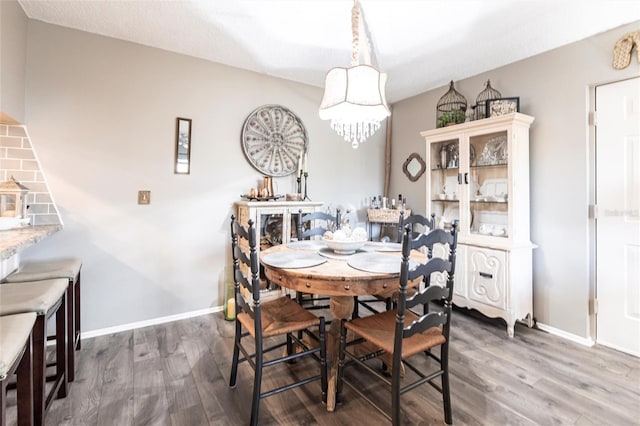 dining area featuring an inviting chandelier and dark hardwood / wood-style floors