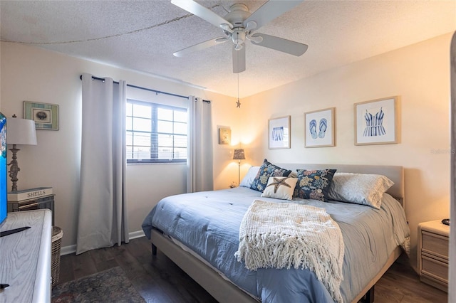 bedroom with ceiling fan, dark hardwood / wood-style floors, and a textured ceiling