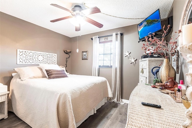 bedroom featuring ceiling fan, wood-type flooring, and a textured ceiling