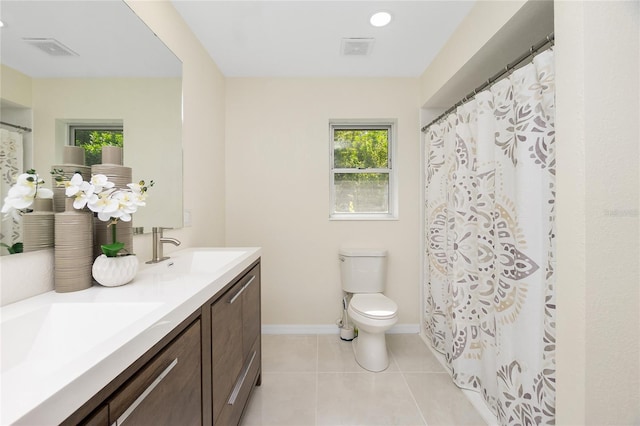 full bath with double vanity, visible vents, toilet, tile patterned flooring, and a sink