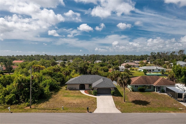 birds eye view of property featuring a residential view and a wooded view