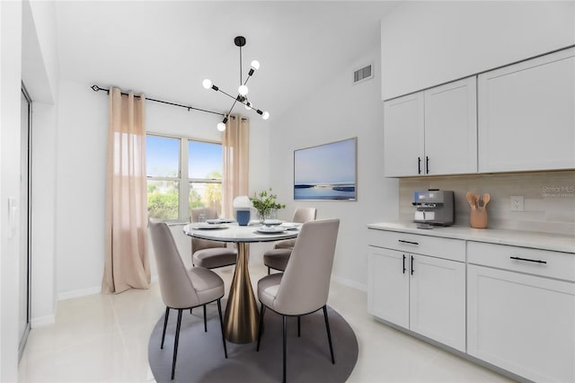 dining space with a chandelier, visible vents, baseboards, and light tile patterned floors