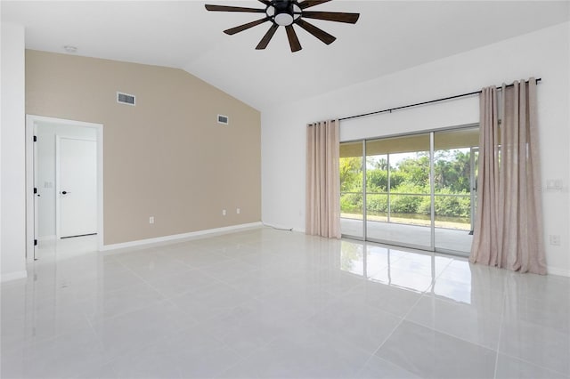 spare room featuring ceiling fan, visible vents, vaulted ceiling, and baseboards