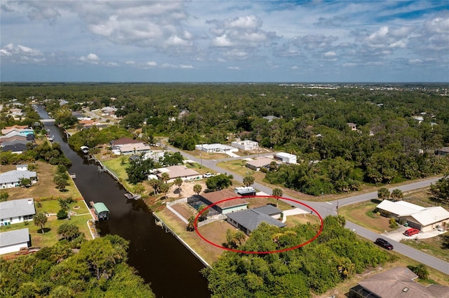 bird's eye view featuring a residential view, a water view, and a wooded view