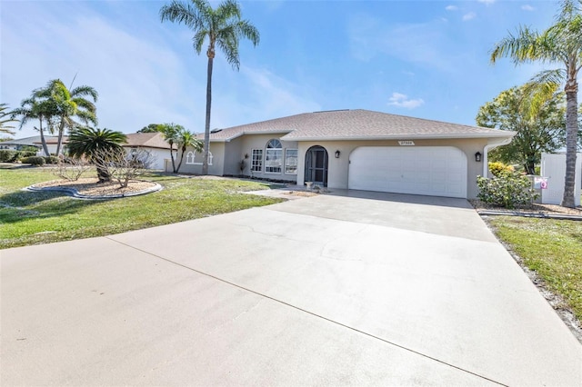 single story home featuring a garage and a front lawn