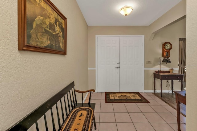 foyer entrance with light tile patterned flooring