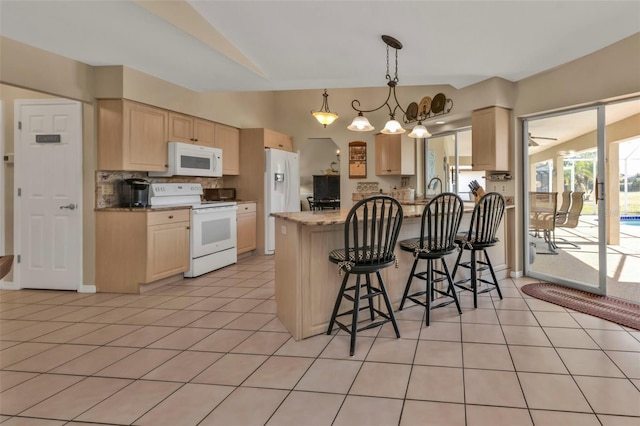 kitchen featuring light brown cabinets, light stone countertops, light tile patterned floors, and white appliances