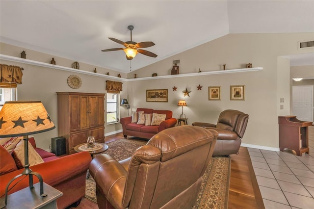 living room featuring hardwood / wood-style floors, vaulted ceiling, and ceiling fan