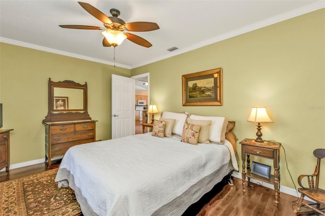 bedroom featuring crown molding, dark hardwood / wood-style floors, and ceiling fan