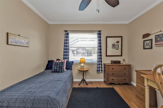 bedroom with ceiling fan, ornamental molding, and light hardwood / wood-style flooring