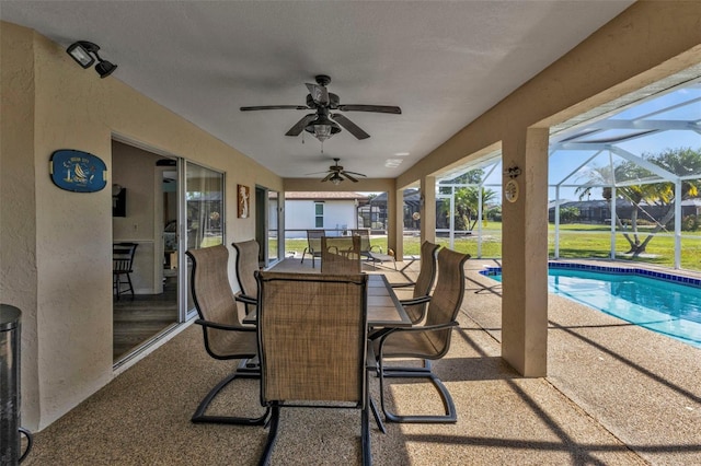 view of patio featuring a lanai and ceiling fan