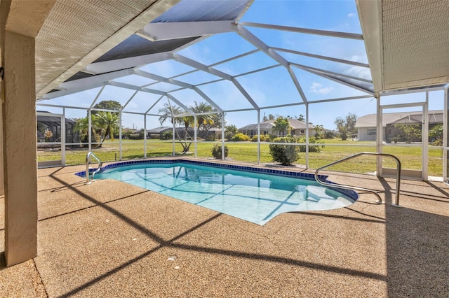 view of pool featuring a yard, a patio area, and glass enclosure