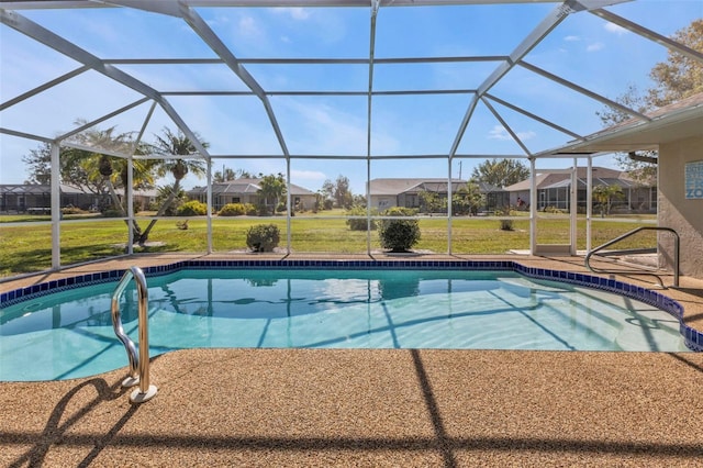 view of pool with a lanai and a lawn