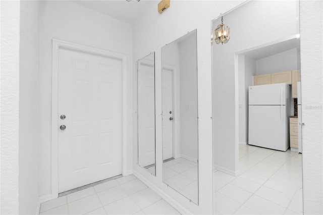 interior space with tile patterned floors and a chandelier