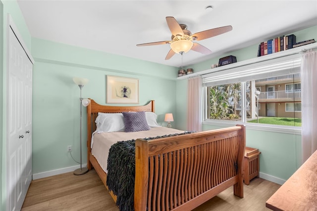 bedroom featuring light hardwood / wood-style flooring, a closet, and ceiling fan