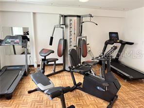 exercise area featuring light parquet flooring