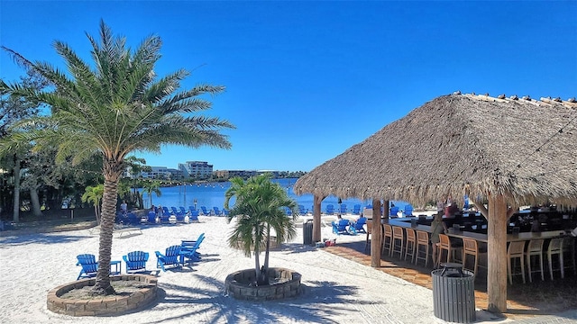 view of community featuring a gazebo, an outdoor bar, and a water view