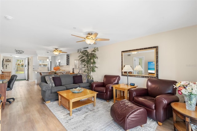 living room featuring light hardwood / wood-style floors and ceiling fan