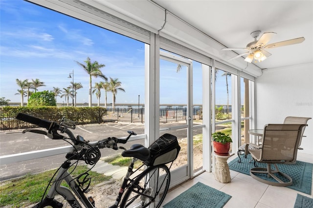 sunroom / solarium featuring ceiling fan