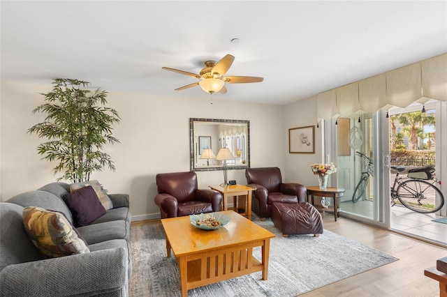 living room with wood-type flooring and ceiling fan