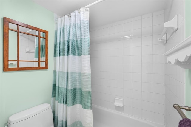 bathroom with shower / bathtub combination with curtain and toilet